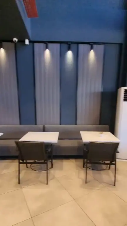 A corner of the room: tables and wall lights